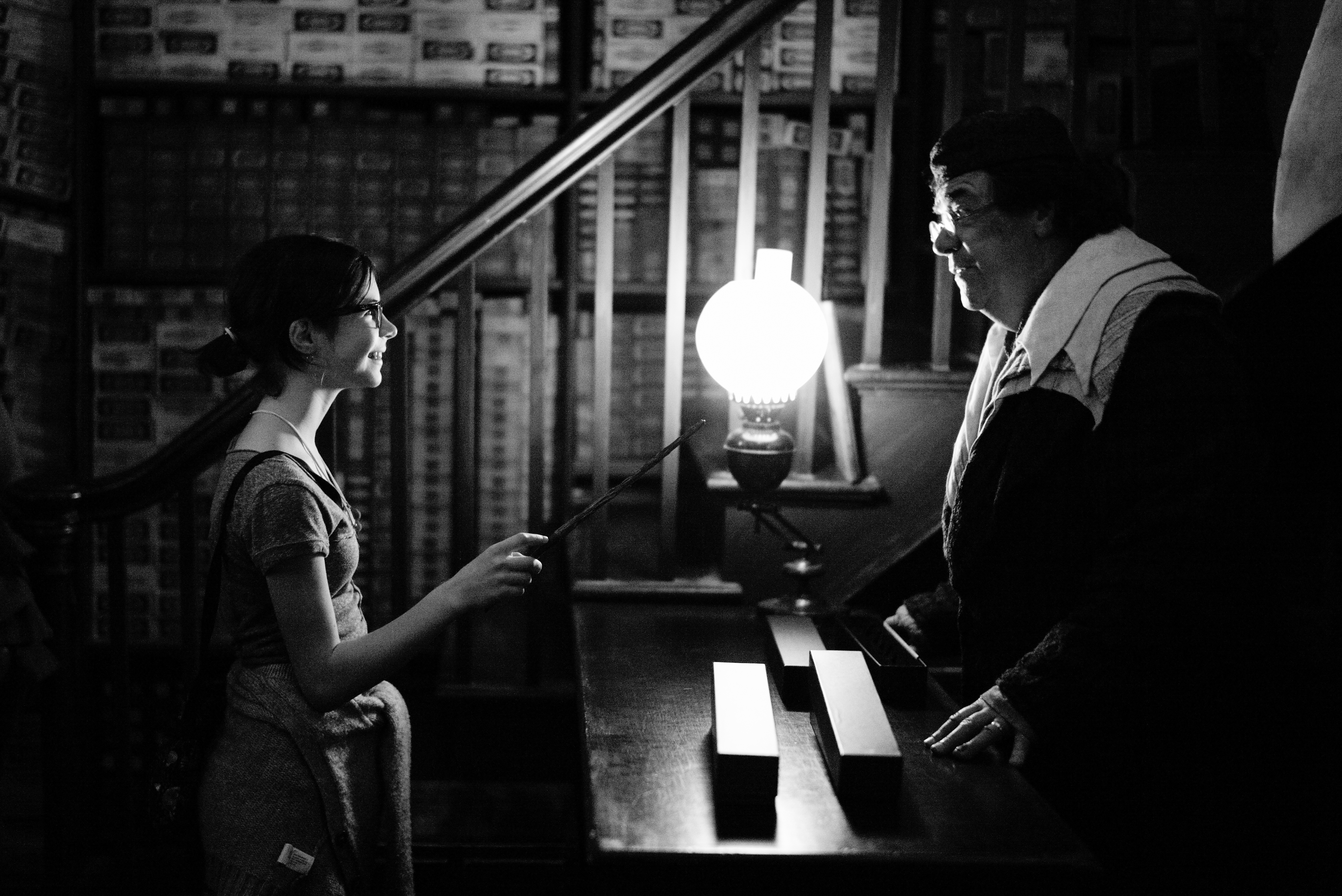 Guest receiving a magic wand at Diagon Alley, Universal Studios, Orlando, Florida. Leica M-P / Summilux 50mm @ f1.7, 1/45, ISO 4000 JPEG from camera using B&W Neutral setting slightly tweaked for exposure.